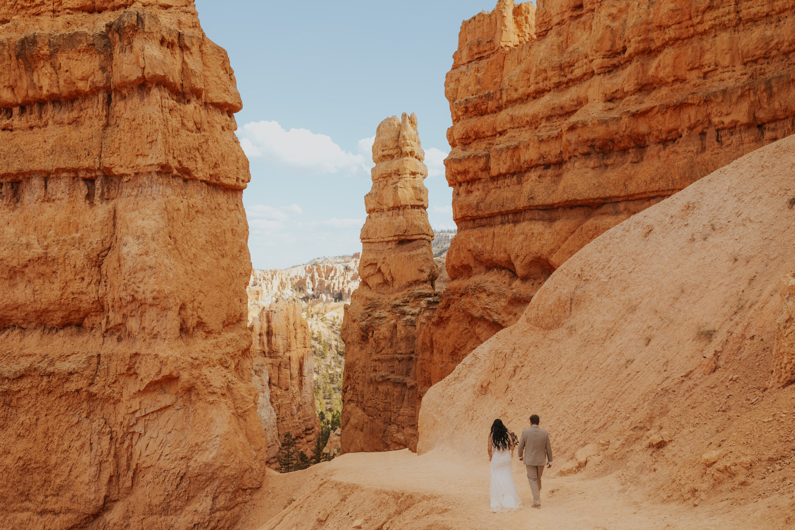 An elopement couple hiking a trail in Bryce Canyon National Park