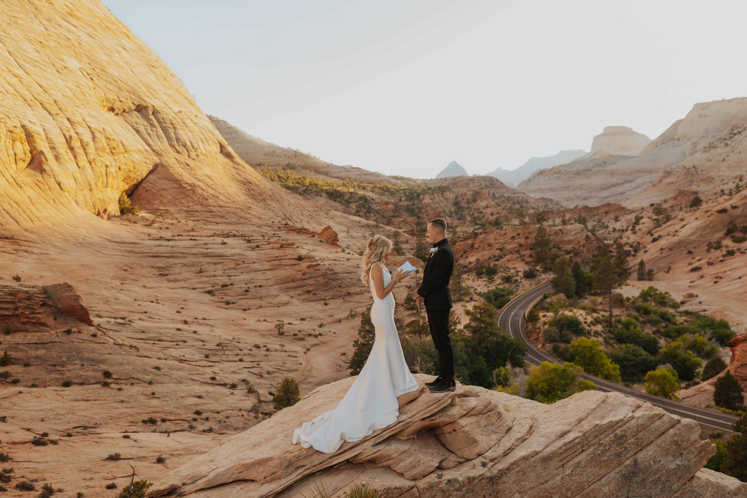 A bride and groom on an overlook in Zion sharing their vows