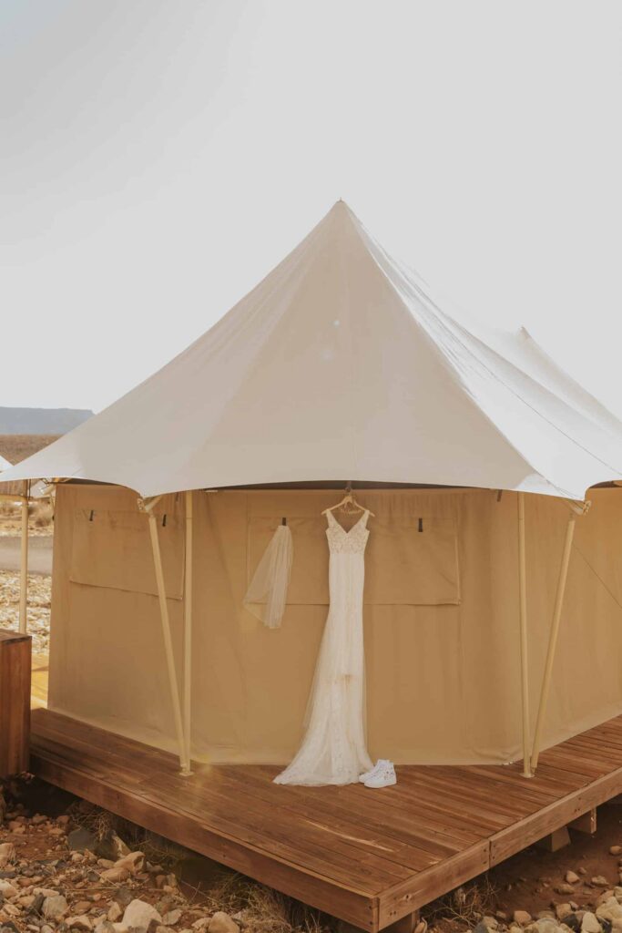 A yurt with a wedding dress hanging on it.