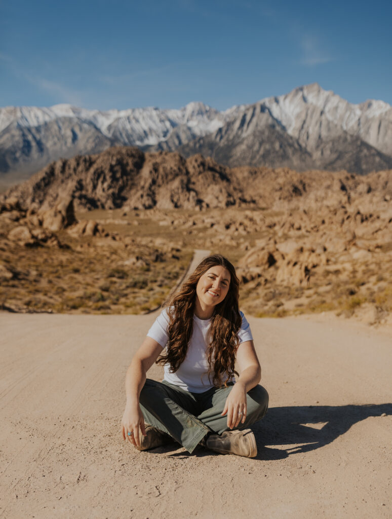 a photo of an elopement photographer with a mountain backdrop