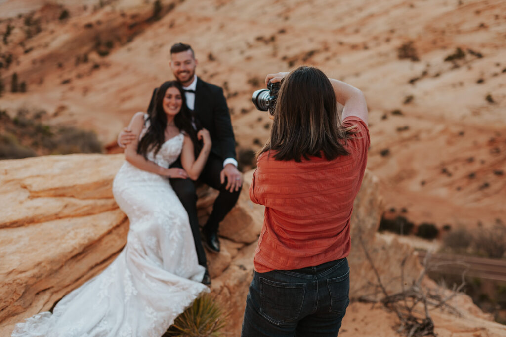 A photographer taking a picture a bridal couple in Zion National Park